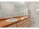 A full bath features a large vanity with double sinks and a built-in cabinet for linens at 6449 S Jamaica Cir, Englewood, CO 80111