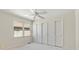 This bedroom features a bright window and a closet with three sliding doors at 6449 S Jamaica Cir, Englewood, CO 80111