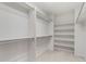 The walk-in closet with shelving and hanging rods provides plenty of storage space at 6449 S Jamaica Cir, Englewood, CO 80111