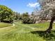 View of a lovely grassy community park with a walking path and mature trees at 6449 S Jamaica Cir, Englewood, CO 80111