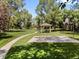 A park featuring a gazebo, basketball court, and volleyball net on a grassy lawn at 6449 S Jamaica Cir, Englewood, CO 80111