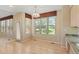 Sunlit dining area features large windows, a door to the deck, and open access to kitchen and dining space at 6449 S Jamaica Cir, Englewood, CO 80111