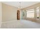 This neutral dining room offers natural light, an adjacent butler's pantry, and plush carpet at 6449 S Jamaica Cir, Englewood, CO 80111