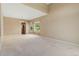This neutral dining room offers natural light, an adjacent butler's pantry, and plush carpet at 6449 S Jamaica Cir, Englewood, CO 80111
