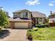 Charming two-story home features a brick facade, well-maintained landscaping, and a three-car garage at 6449 S Jamaica Cir, Englewood, CO 80111