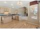 Kitchen and dining area featuring modern appliances, hardwood floors, and an open view to the living space at 6449 S Jamaica Cir, Englewood, CO 80111