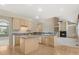 Kitchen with an island, modern appliances, and hardwood floors, open to the living area with a fireplace at 6449 S Jamaica Cir, Englewood, CO 80111