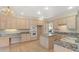 Well-appointed kitchen features stainless steel appliances, an island, and granite countertops with ample cabinet space at 6449 S Jamaica Cir, Englewood, CO 80111