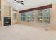 Spacious living room boasts a fireplace, built-in shelving, vaulted ceiling, and large windows with natural light at 6449 S Jamaica Cir, Englewood, CO 80111