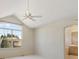 Bright main bedroom with vaulted ceiling, ceiling fan and large windows looking out to the neighborhood at 6449 S Jamaica Cir, Englewood, CO 80111