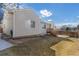 Exterior view of the backyard with a patio and green lawn on a sunny day at 22815 E Progress Ave, Aurora, CO 80015