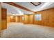 Spacious basement with wood paneling, carpeted floors, and ample room for recreation or storage at 22815 E Progress Ave, Aurora, CO 80015