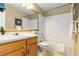 Cozy bathroom with a vanity, bathtub-shower combination, and tiled walls at 22815 E Progress Ave, Aurora, CO 80015