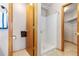 Bright bathroom featuring a walk-in shower, tile flooring, and a closet at 22815 E Progress Ave, Aurora, CO 80015