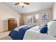Bright bedroom featuring a comfortable bed with blue accents and a ceiling fan at 22815 E Progress Ave, Aurora, CO 80015