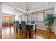The dining room features beautiful hardwood floors, stylish decor, a modern chandelier, and ample natural light at 22815 E Progress Ave, Aurora, CO 80015