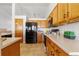 Efficient kitchen with light wood cabinets, modern appliances, and ample counter space for meal preparation at 22815 E Progress Ave, Aurora, CO 80015
