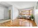 Bright living room with hardwood floors, bay window, comfortable seating, and plenty of natural light at 22815 E Progress Ave, Aurora, CO 80015