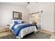 Serene main bedroom with a walk-in closet featuring stylish barn doors, neutral colors, and warm lighting at 22815 E Progress Ave, Aurora, CO 80015