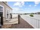 Spacious back patio featuring stunning lake views and a white fence at 15555 E 40Th Ave # 36, Denver, CO 80239