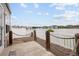 Lovely back patio featuring peaceful lake views and a white fence at 15555 E 40Th Ave # 36, Denver, CO 80239
