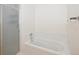 Bright bathroom features a modern bathtub with a glass shower door at 15555 E 40Th Ave # 36, Denver, CO 80239