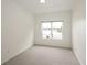 Cozy bedroom featuring neutral carpet and a window with a beautiful lake view at 15555 E 40Th Ave # 36, Denver, CO 80239