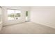 Bright bedroom with lake view, ample natural light, and access to an outdoor patio at 15555 E 40Th Ave # 36, Denver, CO 80239