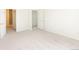 Neutral bedroom featuring neutral walls, neutral carpet, and an open doorway at 15555 E 40Th Ave # 36, Denver, CO 80239