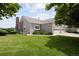 Lovely home exterior featuring a manicured lawn and an attached two car garage at 15555 E 40Th Ave # 36, Denver, CO 80239