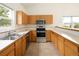 Bright eat-in kitchen with stainless steel appliances and light-colored tile flooring at 15555 E 40Th Ave # 36, Denver, CO 80239
