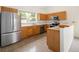 Well-lit kitchen features stainless steel appliances and wood cabinets for a modern, functional design at 15555 E 40Th Ave # 36, Denver, CO 80239