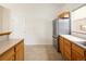 This kitchen has stainless steel refrigerator, light cabinets, and tile flooring at 15555 E 40Th Ave # 36, Denver, CO 80239