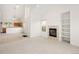 Open concept living space with fireplace, custom shelves, and view to the kitchen at 15555 E 40Th Ave # 36, Denver, CO 80239