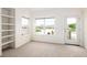 Bright living room with built-in shelving, patio access, and serene lake views at 15555 E 40Th Ave # 36, Denver, CO 80239