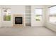 Bright living room with fireplace and custom built-in shelves with a view of the lake at 15555 E 40Th Ave # 36, Denver, CO 80239