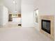 Inviting living room featuring a fireplace and an open floor plan leading to the kitchen at 15555 E 40Th Ave # 36, Denver, CO 80239