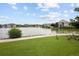 Scenic view of a tranquil pond surrounded by lush greenery and charming homes, with a paved walkway at 15555 E 40Th Ave # 36, Denver, CO 80239