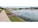 Scenic view of a tranquil pond surrounded by lush greenery and charming homes, with rocky banks at 15555 E 40Th Ave # 36, Denver, CO 80239