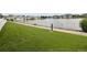 Serene view of a tranquil pond surrounded by lush greenery and charming homes, with a paved walkway at 15555 E 40Th Ave # 36, Denver, CO 80239