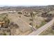 An aerial perspective showing the house, surrounded by a vast tract of land, and bordering a public road at 3303 Wolfensberger Rd, Sedalia, CO 80135
