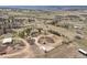Sprawling aerial image showcasing a residence and adjacent buildings nestled within a large rural landscape at 3303 Wolfensberger Rd, Sedalia, CO 80135