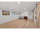 Spacious basement with hardwood floors and rustic sliding barn door at 3303 Wolfensberger Rd, Sedalia, CO 80135