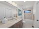 Well-lit bathroom featuring a shower-tub, modern fixtures, and a large mirror at 3303 Wolfensberger Rd, Sedalia, CO 80135