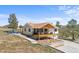 Exterior view of the home with a porch, deck, and large yard at 3303 Wolfensberger Rd, Sedalia, CO 80135