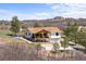 Exterior view of the home with a deck, porch, and driveway at 3303 Wolfensberger Rd, Sedalia, CO 80135