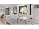 A gourmet kitchen features white cabinets, stone countertops, a farmhouse sink, and large windows with a view at 3303 Wolfensberger Rd, Sedalia, CO 80135