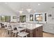 Bright kitchen featuring a large island with seating and a view from the sink at 3303 Wolfensberger Rd, Sedalia, CO 80135