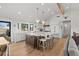Gourmet kitchen with white cabinets, a large center island and modern appliances at 3303 Wolfensberger Rd, Sedalia, CO 80135