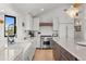 The modern kitchen features stone countertops, white cabinets, and stainless steel appliances for a contemporary feel at 3303 Wolfensberger Rd, Sedalia, CO 80135